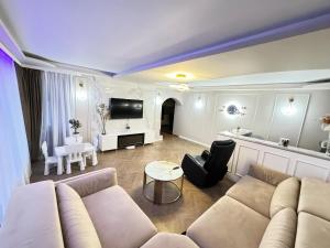 a living room with a couch and a tv at Casa Silvia in Eforie Nord