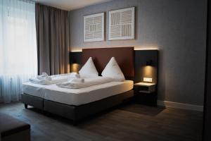 Postel nebo postele na pokoji v ubytování JUNIK Apartments Oberhausen
