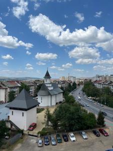 a view of a city with a church and a street at Apartament nou neo tower in Suceava