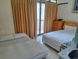 Letto o letti in una camera di Tianmu Star Urban Living