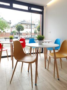 a group of tables and chairs in a room at Bilbao ROOMS & KITCHEN Santutxu in Bilbao