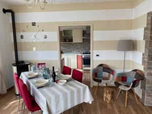 a dining room with a table and red chairs at Agritur Chalet Belvedere in Giovo