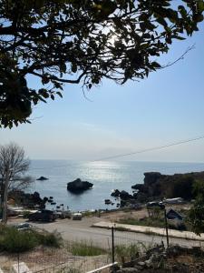 a view of the ocean from a parking lot at Family hotel Delfina in Tyulenovo +7 photos
