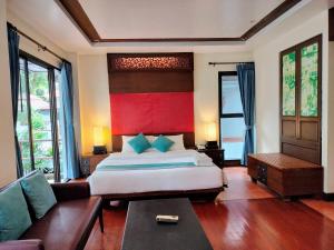 a bedroom with a large bed and a couch at Chang Buri Resort & Spa in Ko Chang