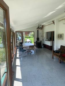 a living room with a table and chairs at Casa Herban in Teliucu Inferior