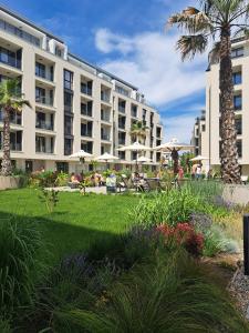a hotel building with a lawn and palm trees at Lana Del Capos in Saints Constantine and Helena