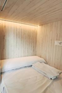 a bed in a room with a wooden wall at Adventure Hostel Madrid in Madrid +48 photos