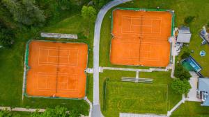 an overhead view of two tennis courts with orange roofs at Hotel Kranjska Gora in Kranjska Gora