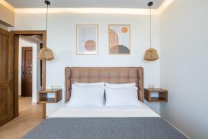 a bedroom with a bed with two night stands at Elite Luxury Villas in Afiartis +37 photos