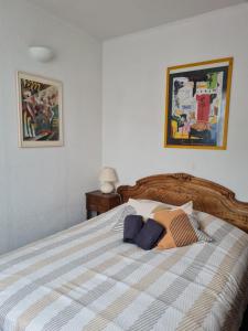 a bedroom with a bed with a striped comforter at La Gleyzinière 2 in Allevard