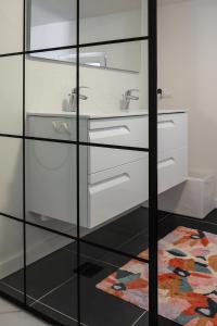 a bathroom with glass cabinets and a sink at ViaAmbioriX in Tongeren +22 photos