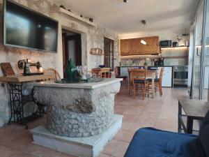 a kitchen and living room with a tv on the wall at Appartement Balthasar - Turm Krk in Sveti Vid-Miholjice
