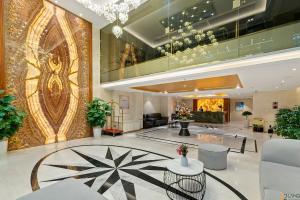 a lobby of a hotel with a large room at 22Land Hotel Saigon in Ho Chi Minh City