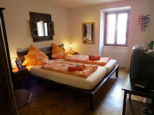 a bedroom with two beds and a television at Appartement Balthasar - Turm Krk in Sveti Vid-Miholjice