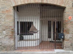 a door with a iron gate in front of a building at Gites Torreillans - Nid douillet - Gite bleu in Torreilles