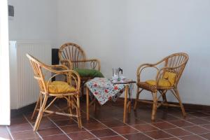 a table and two chairs and a table and a table and a table and chairs at Casa Franguella - Uliveto sul mare in Lavagna