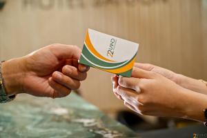 two people holding up a piece of paper at 22Land Hotel Saigon in Ho Chi Minh City