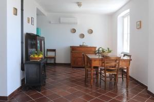 a dining room with a table and a wood stove at Casa Franguella - Uliveto sul mare in Lavagna