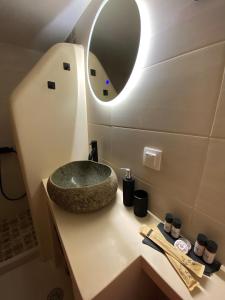 a bathroom with a sink and a mirror on a counter at Babatseratsi skyrian studio 1 in Skiros +63 photos