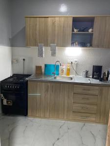 a kitchen with a sink and a stove at New modern apartment in Bijilo in Bijilo