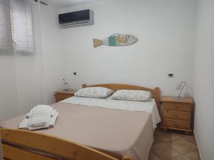 a bedroom with a bed with a phone on it at Appartamenti Za Barbara in Lampedusa
