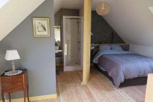 a bedroom with a large bed and a staircase at Les Gîtes de Douar Bouillon in La Chapelle-Neuve +33 photos