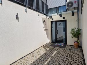 a door to a building with a tiled floor at Sweet Retreat Apartment Lahr in Lahr