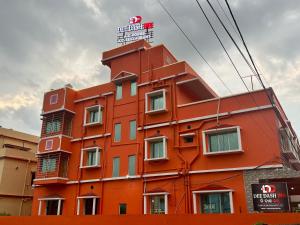 an orange building with a sign on top of it at Dee Dash Inn in Bhubaneshwar