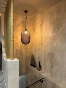 aendant light hanging from a wall with a boat on it at Casa Mint in Sozopol