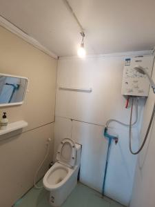 a small bathroom with a toilet and a sink at Panakluea at Kokuang Homestay in Ban Na Lae