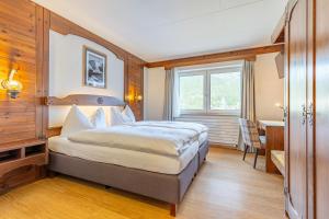 Letto o letti in una camera di Hotel Dischma