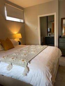 a bedroom with a large white bed with a window at Seapoint Lodge in Westport