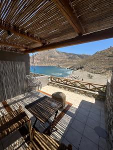 a patio with a table and a view of the ocean at Marmari Paradise Resort Hotel in Marmari