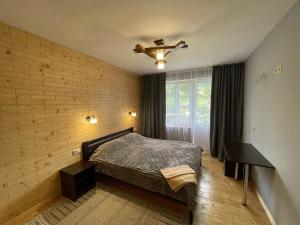 a bedroom with a bed and a ceiling fan at Nad Prutom in Vorokhta