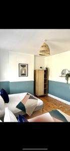 a bedroom with two beds and a pendant light at Spacious and stylish home Bath in Bath +11 photos
