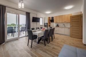 a kitchen and dining room with a table and chairs at Villa Milutin 1 in Vrsi