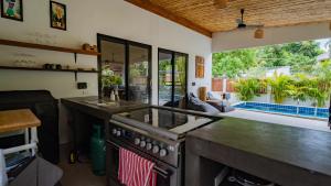 a kitchen with a stove and a sink at Temple villas Koh Phangan in Koh Phangan