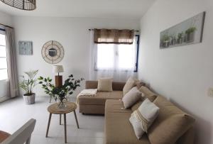 a living room with a couch and a table at Atardecer in La Santa