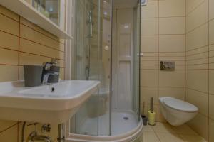 a bathroom with a sink and a shower and a toilet at Polina Apartmani in Klenovica +19 photos
