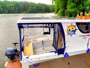 a boat with a solar panel on the back at Jachty, Czartery, Łodzie bez patentu RELAX Ruciane-Nida in Ruciane-Nida