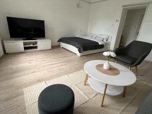 a living room with a bed and a table at Mavino Apartment Zagreb in Zagreb