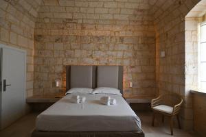 Postel nebo postele na pokoji v ubytování Palazzo Momi