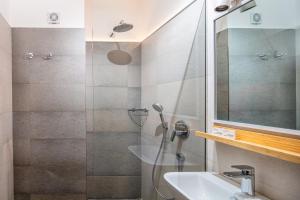 a bathroom with a shower and a sink at Appartamenti BIANCO NERO in Lignano Sabbiadoro +20 photos