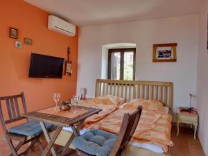 a bedroom with a bed and a table with chairs at Appartement Caspar- Turm Krk in Sveti Vid-Miholjice