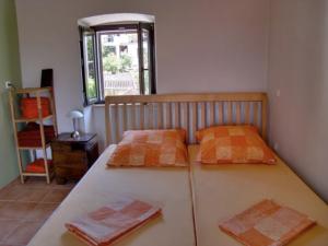 a bedroom with a bed with two pillows on it at Appartement Caspar- Turm Krk in Sveti Vid-Miholjice