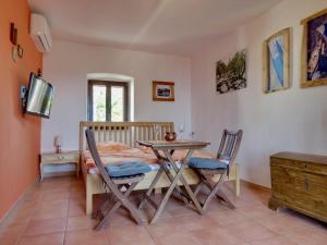 a dining room with a table and chairs and a bed at Appartement Caspar- Turm Krk in Sveti Vid-Miholjice