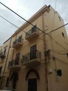 a building with balconies on the side of it at Domus Case Vacanze civico del mare in Castellammare del Golfo