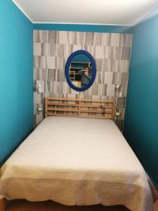 a bedroom with a bed with a mirror on the wall at Domus Case Vacanze civico del mare in Castellammare del Golfo