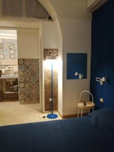 a bedroom with a blue bed and a blue lamp at Domus Case Vacanze civico del mare in Castellammare del Golfo