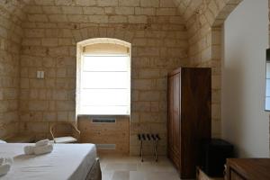 Postel nebo postele na pokoji v ubytování Palazzo Momi